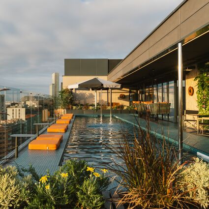 Rooftop pool with sun loungers and city skyline views at The Social Hub Barcelona Sisi