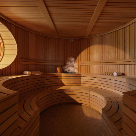 An empty sauna with steam rising and light shining in